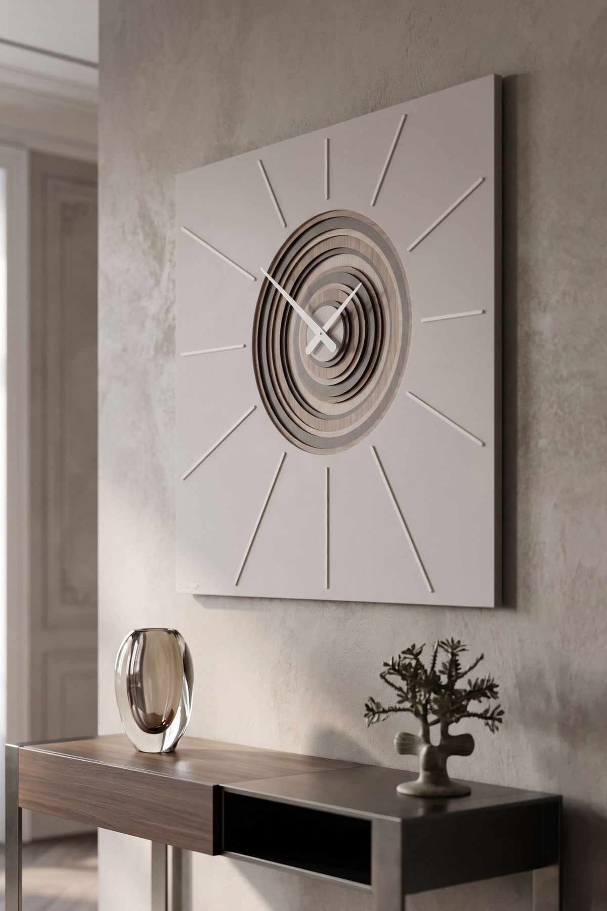 CalleaDesign Helios wall clock in Sand finish, side view above a contemporary console