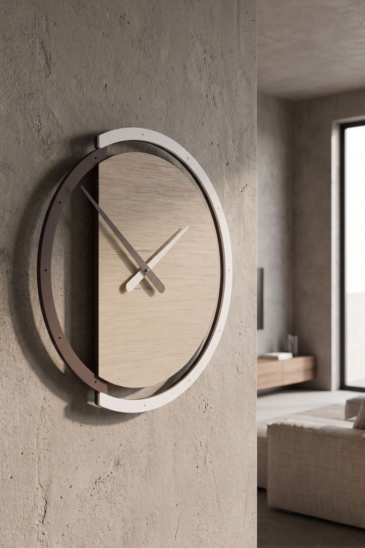 CalleaDesign Zaki wall clock in Pickled Oak finish on a textured concrete wall in a contemporary interior